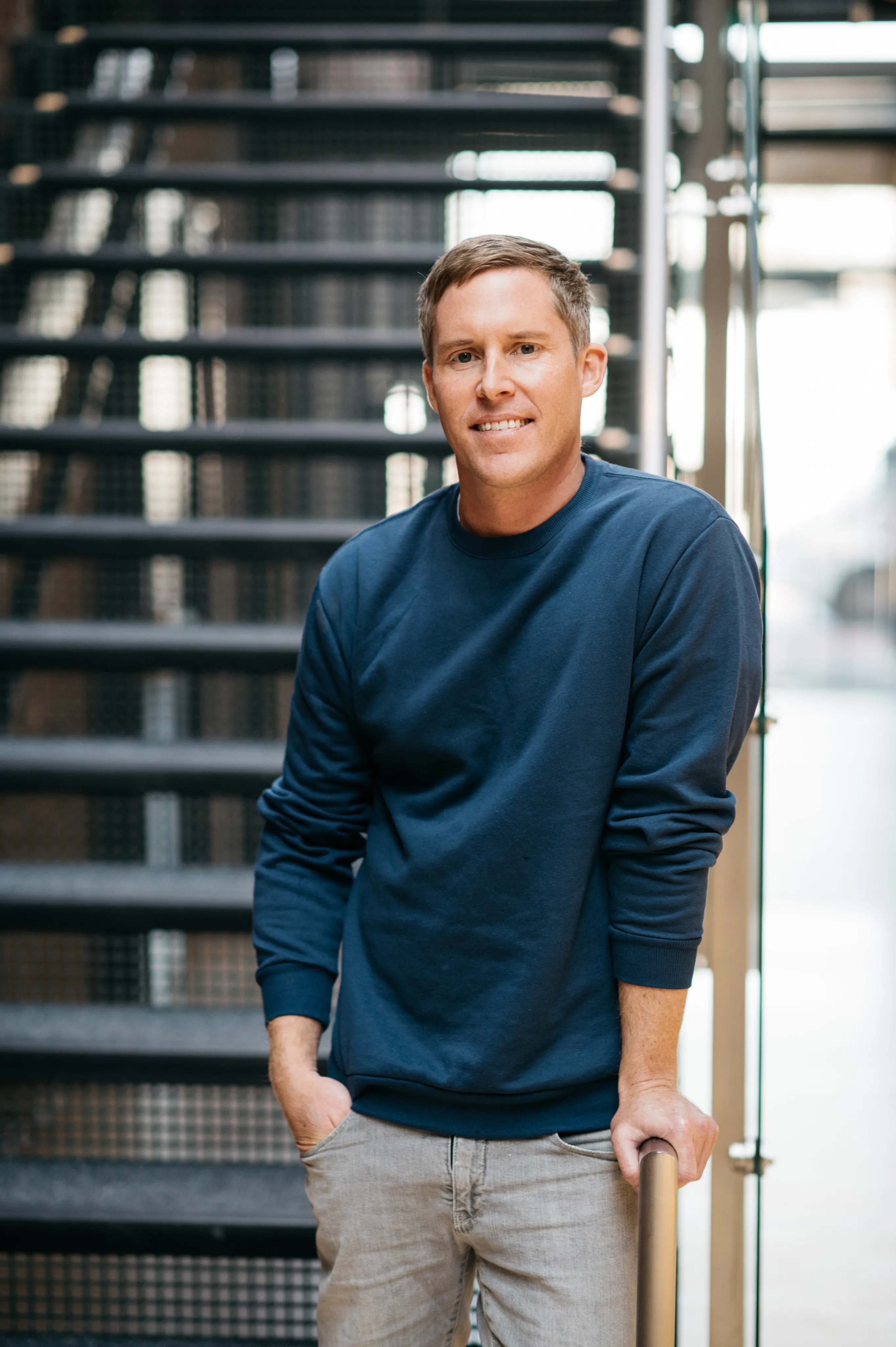 An Equity Guide standing on a metal staircase, smiling
